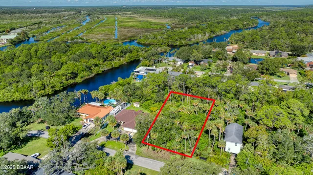 an aerial view of a houses with a yard