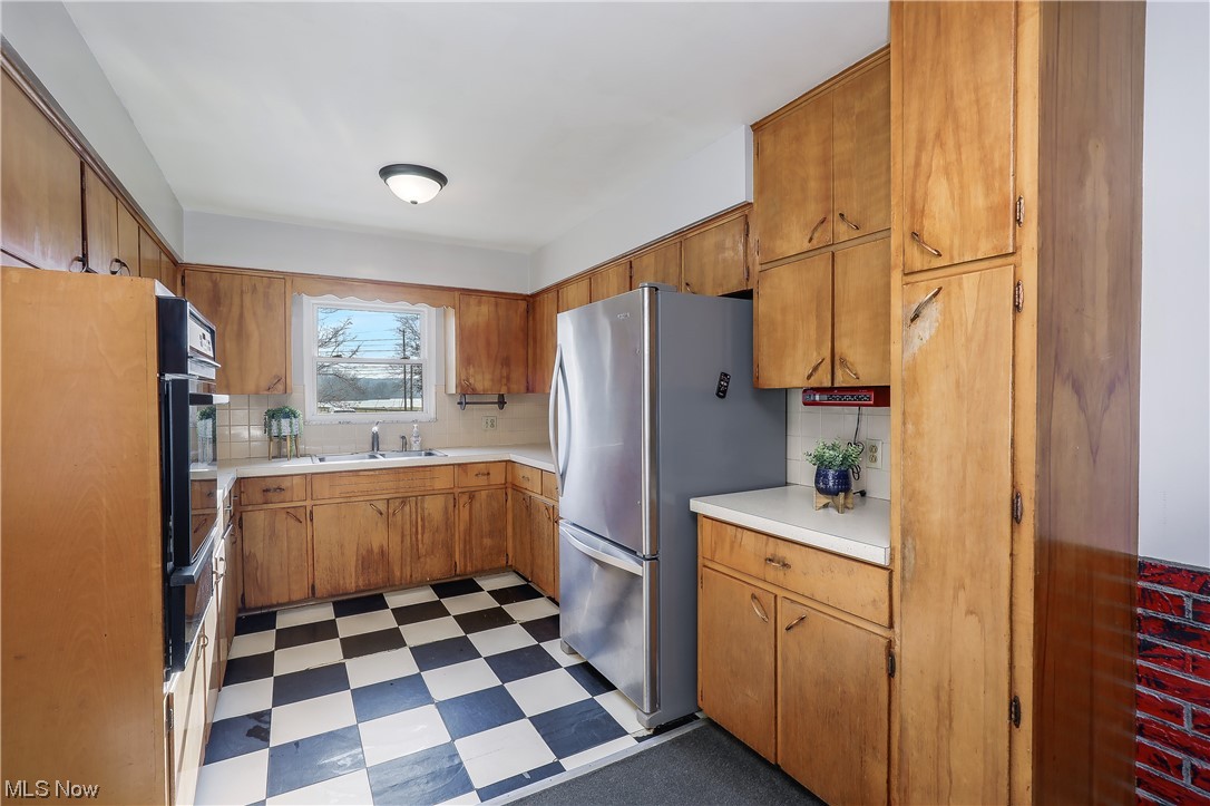 3373 Cormany Road Akron, OH 44319 - Photo 7 of 29 Kitchen with sink, stainless steel appliances, and light tile floors