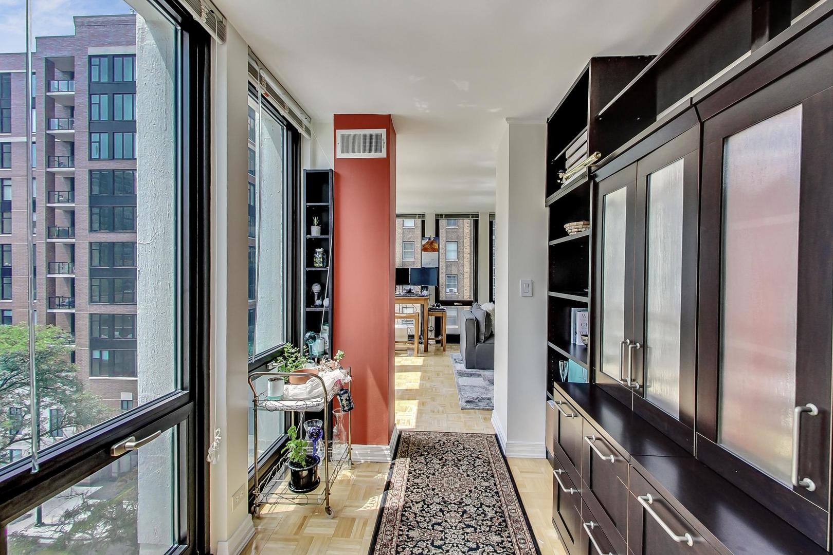 1 East Scott Street, Unit 709 Chicago, IL 60610 - Photo 19 of 31 a hallway with wooden floor and a potted plant