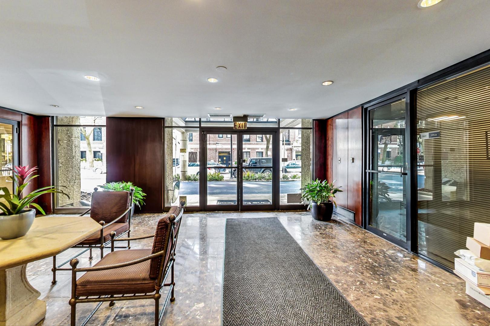 1 East Scott Street, Unit 709 Chicago, IL 60610 - Photo 5 of 31 a living room with furniture and large windows