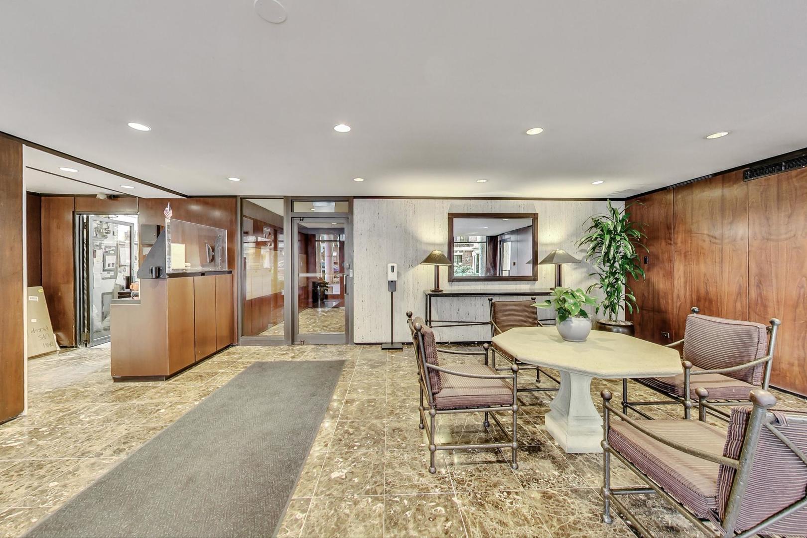 1 East Scott Street, Unit 709 Chicago, IL 60610 - Photo 7 of 31 a living room with furniture a window and kitchen view