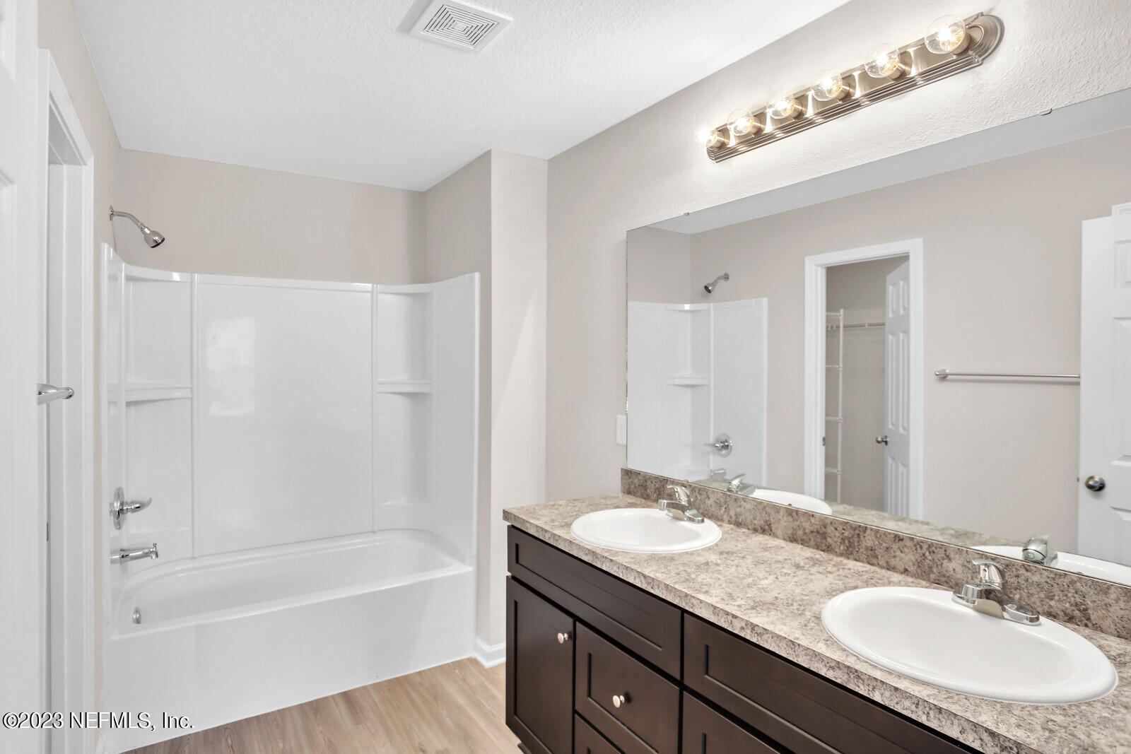 7276 Ridgeway Road North Jacksonville, FL 32244 - Photo 17 of 26 a bathroom with a granite countertop sink a mirror a bathtub and shower
