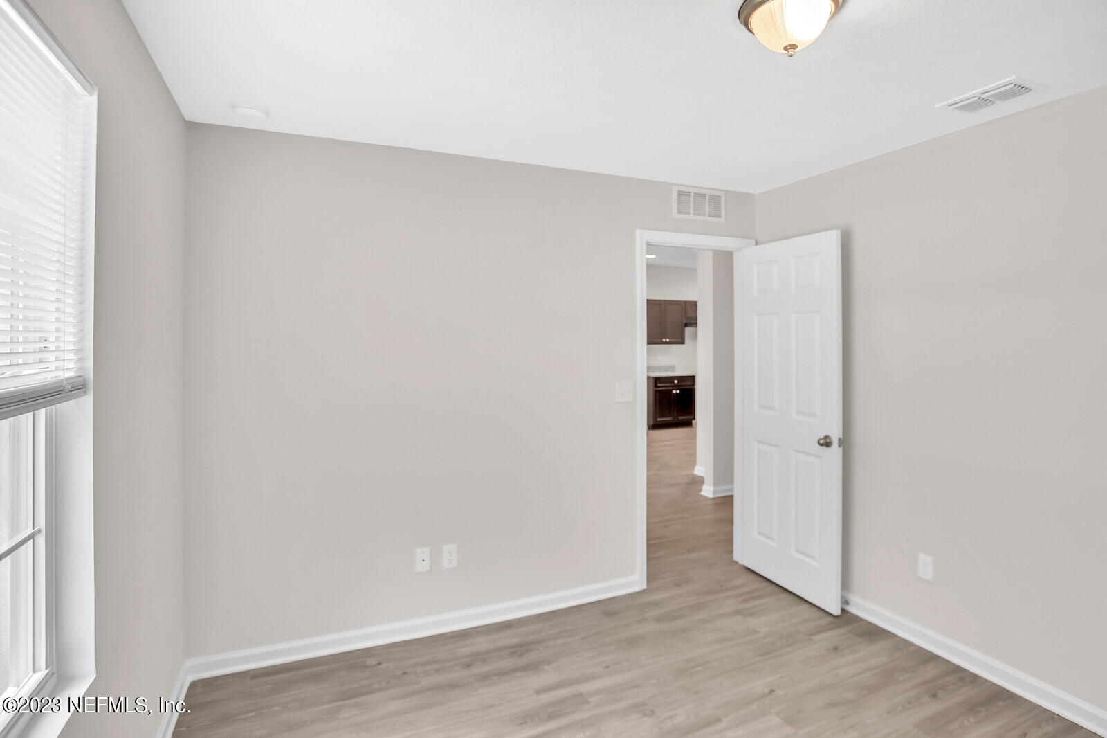 7276 Ridgeway Road North Jacksonville, FL 32244 - Photo 19 of 26 a view of an empty room with wooden floor and a window