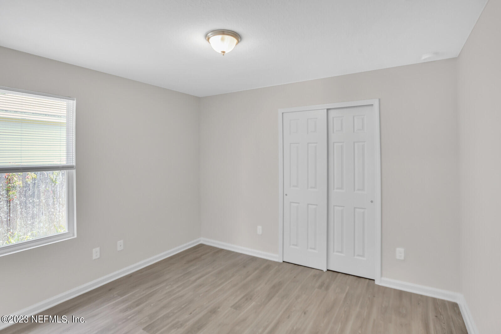 7276 Ridgeway Road North Jacksonville, FL 32244 - Photo 20 of 26 an empty room with wooden floor and windows