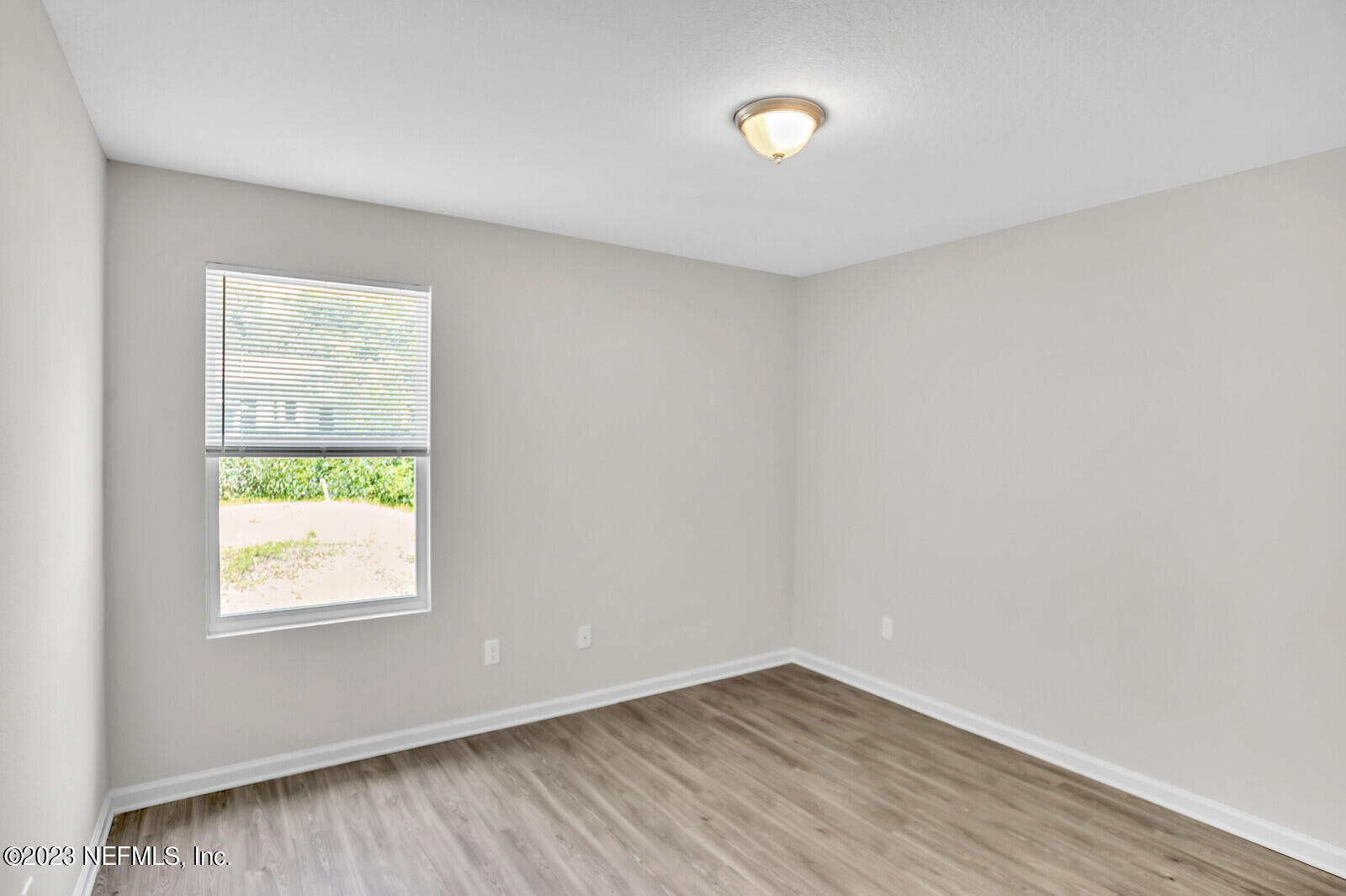 7276 Ridgeway Road North Jacksonville, FL 32244 - Photo 22 of 26 an empty room with wooden floor and windows
