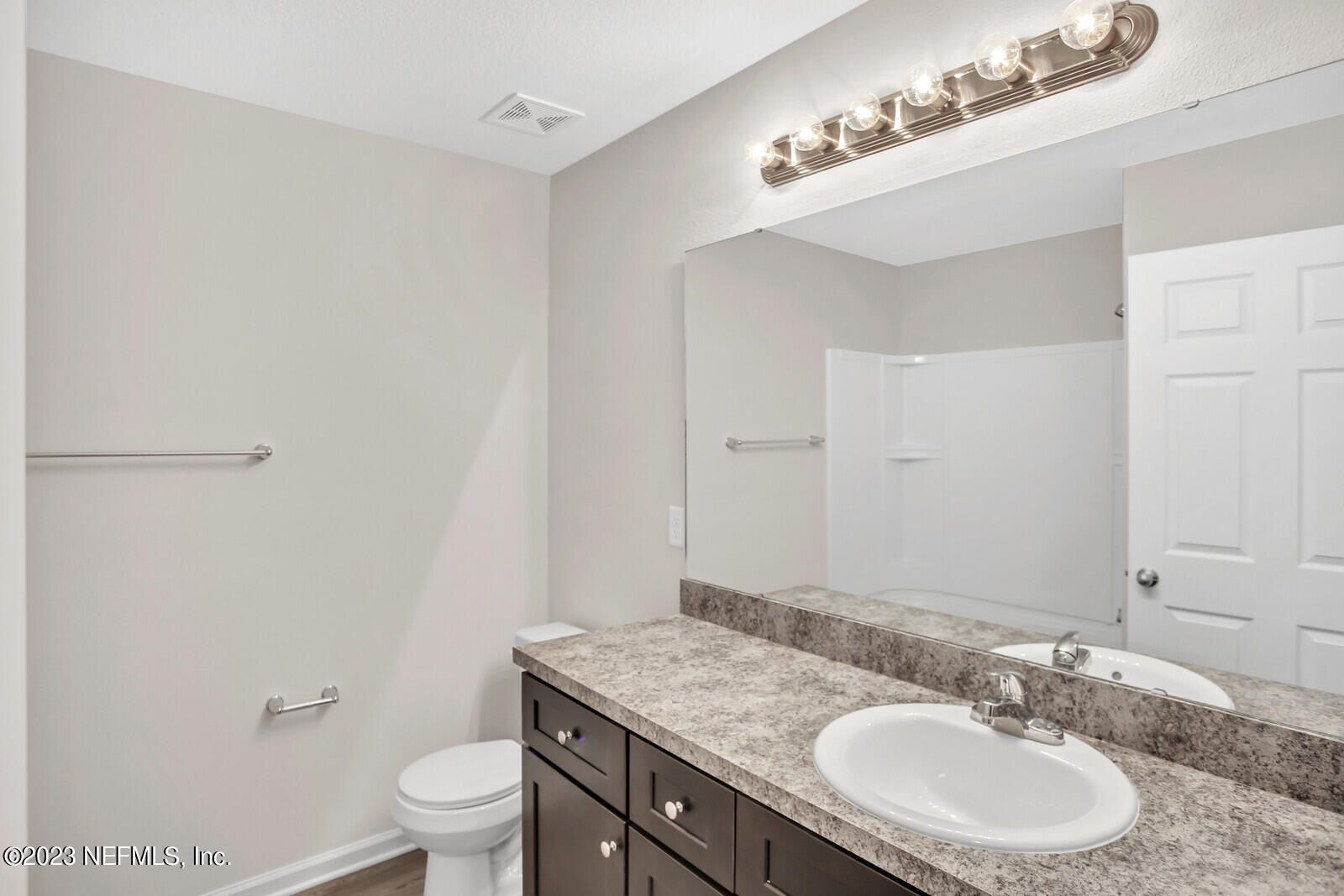 7276 Ridgeway Road North Jacksonville, FL 32244 - Photo 24 of 26 a bathroom with a granite countertop sink a toilet and a mirror