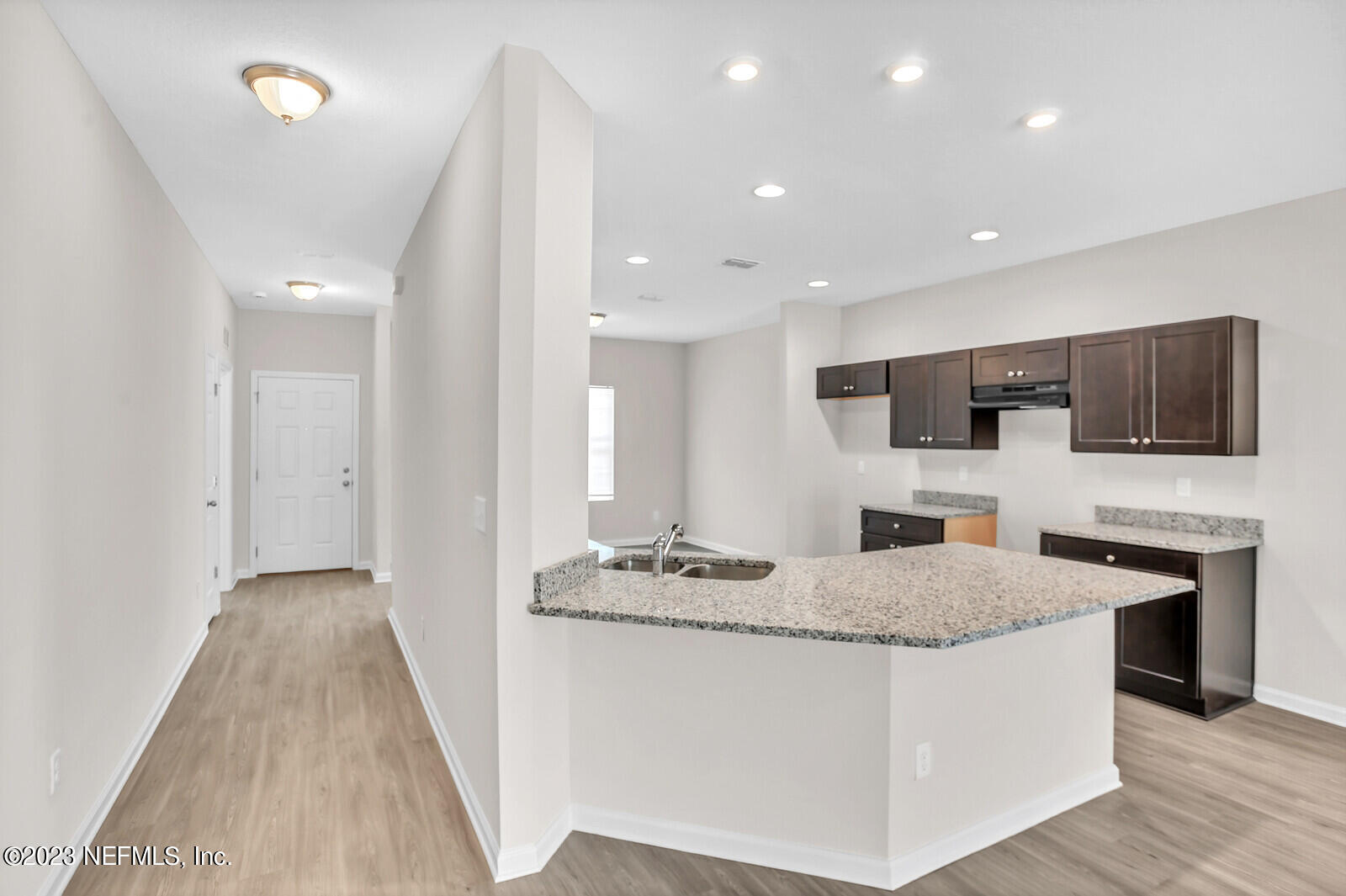 7276 Ridgeway Road North Jacksonville, FL 32244 - Photo 6 of 26 a large kitchen with kitchen island granite countertop a stove top oven a sink a counter space and cabinets