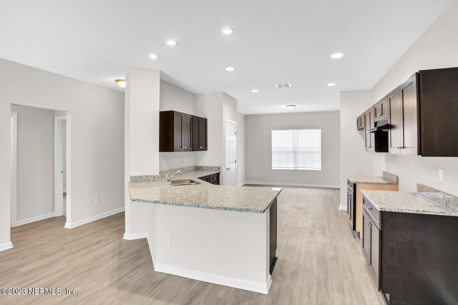 7276 Ridgeway Road North Jacksonville, FL 32244 - Photo 7 of 26 a living room with stainless steel appliances kitchen island granite countertop a sink and a flat screen tv
