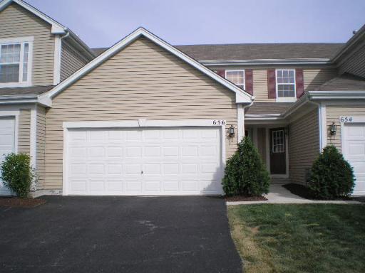 656 Chestnut Ridge Minooka, IL 60447 - Photo 1 of 1 a view of house with garage and plants