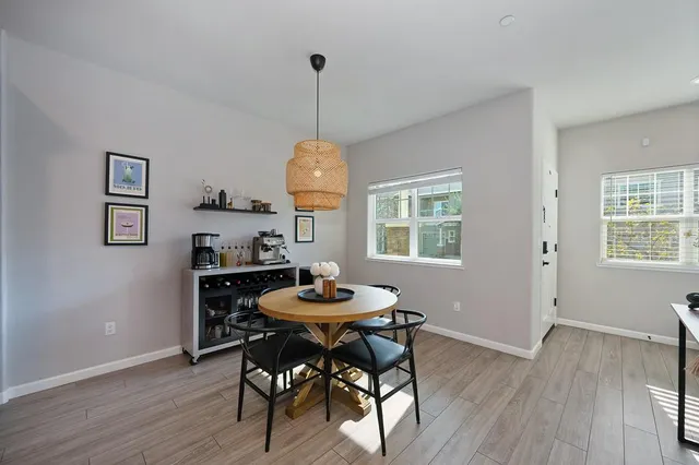 a view of a dining room with furniture window and wooden floor
