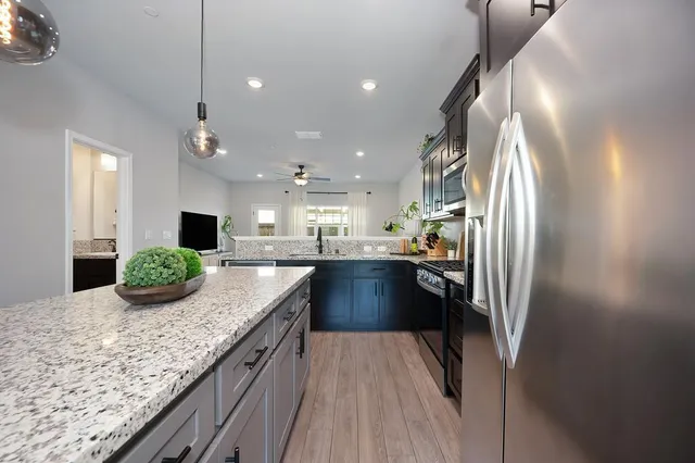 a kitchen with kitchen island granite countertop lots of counter top space