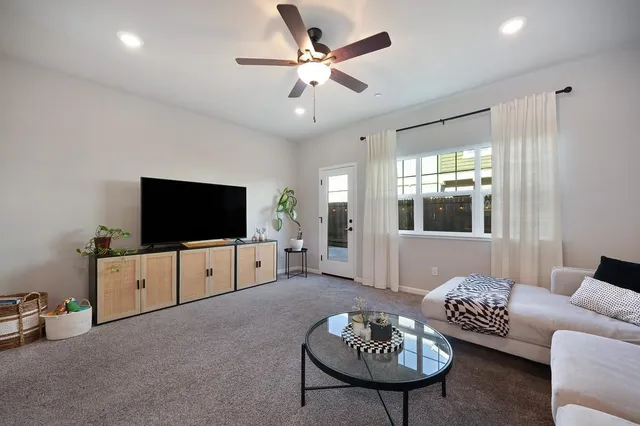 a living room with furniture and kitchen view