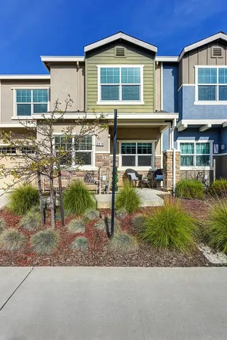 a view of a house with backyard porch and sitting area