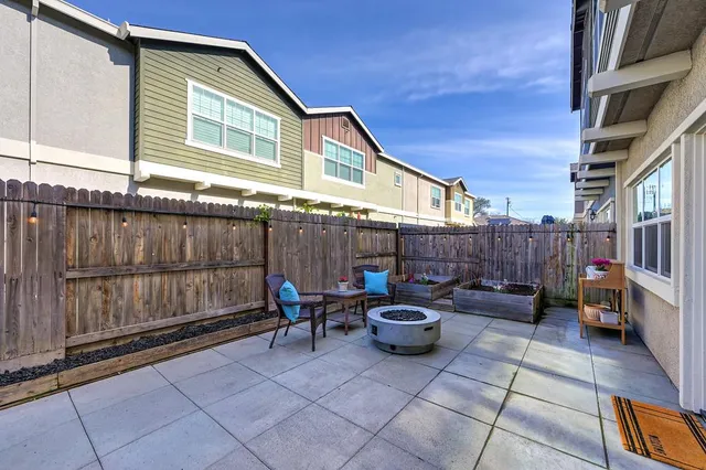 a backyard of a house with outdoor seating