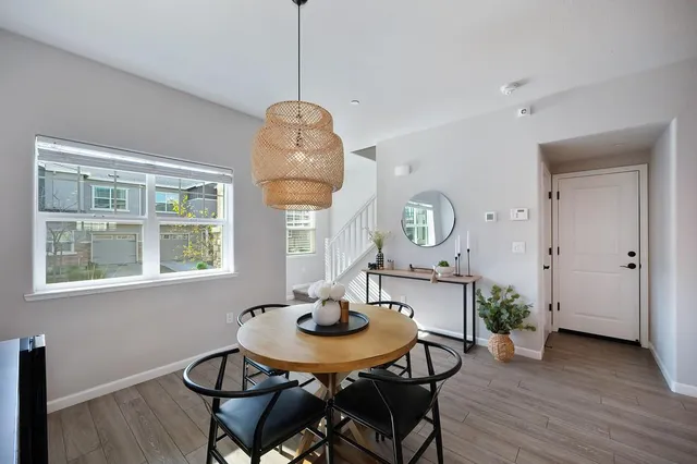 a view of a dining room with furniture window and wooden floor