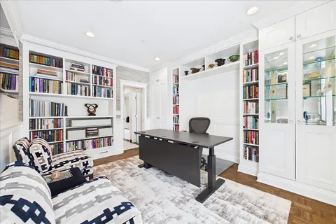 a living room with furniture cabinets and a book shelf