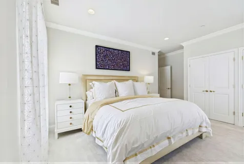 a bedroom with a bed and a view of bathroom