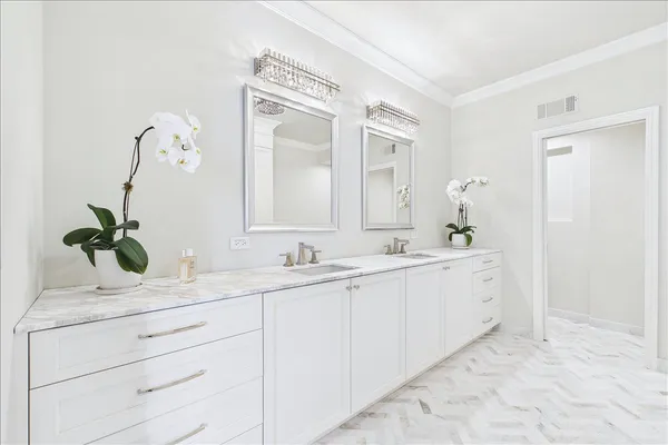 a large white bathroom with a double vanity sink mirror and