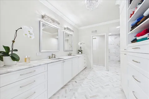 a large white bathroom with a double vanity sink mirror and