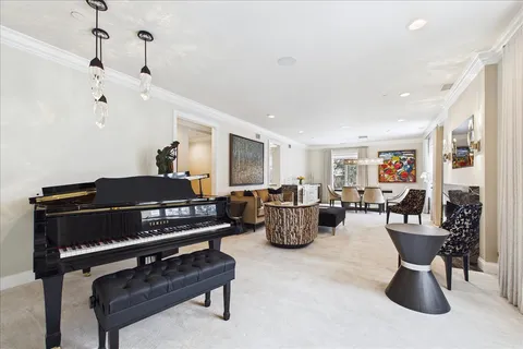 a living room with furniture a rug and a chandelier