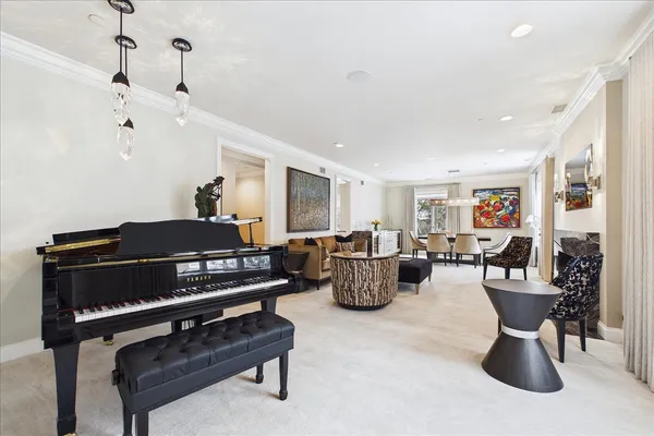 a dining room with furniture a chandelier and window