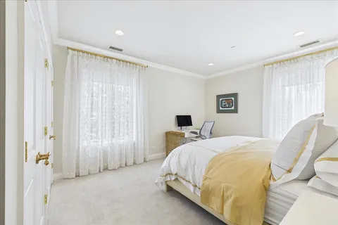 a spacious bedroom with a bed and a couch