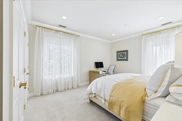 a bedroom with a bed a desk and chair