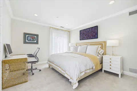 a bedroom with a bed a desk and chair