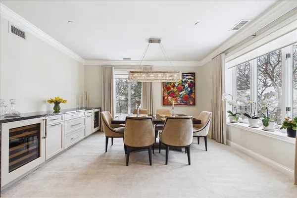 a dining room with furniture a livingroom view and wooden floor