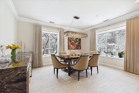 a dining room with furniture a livingroom view and wooden floor