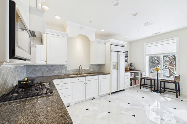 a view of a workspace with furniture and windows