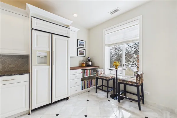 a large white kitchen with chandelier