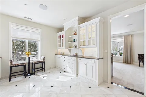 a large white kitchen with chandelier