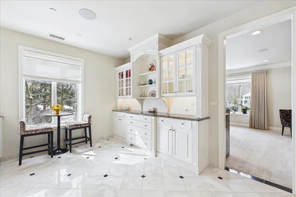 a kitchen with granite countertop white cabinets and white appliances