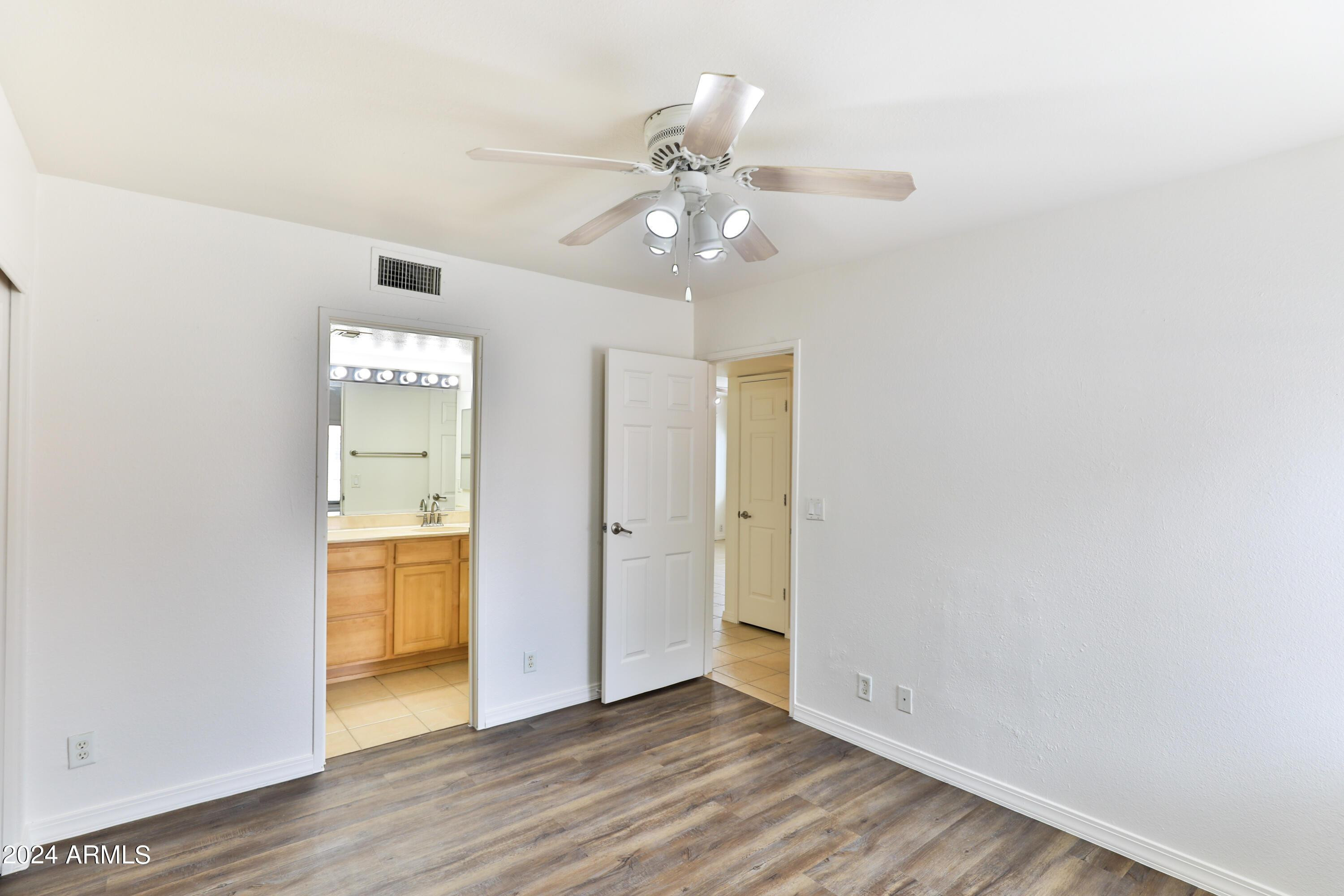 330 South Beck Avenue, Unit 201 Tempe, AZ 85281 - Photo 11 of 17 a view of an empty room and wooden floor and a ceiling fan