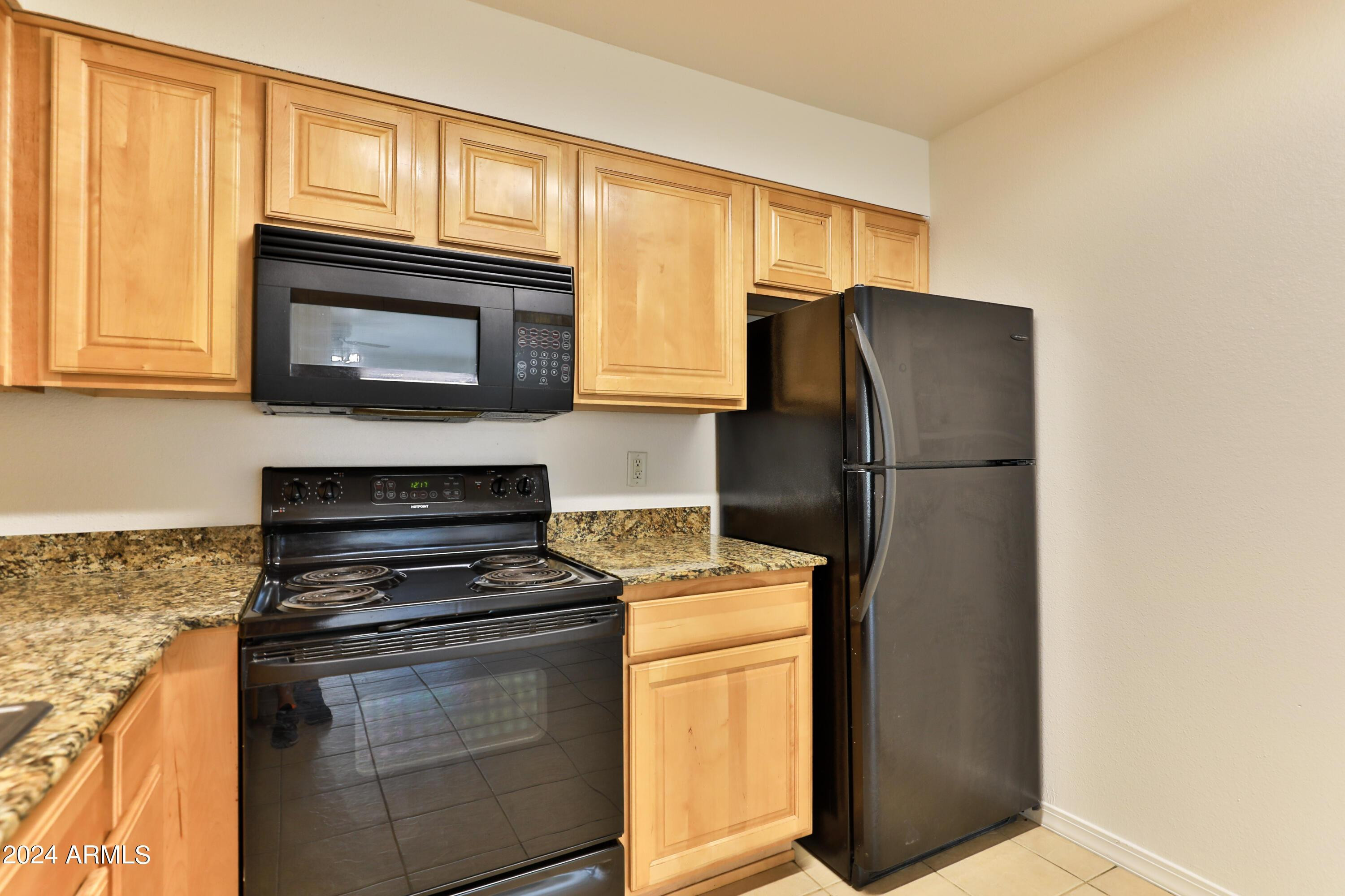 330 South Beck Avenue, Unit 201 Tempe, AZ 85281 - Photo 9 of 17 a kitchen with granite countertop cabinets and steel stainless steel appliances