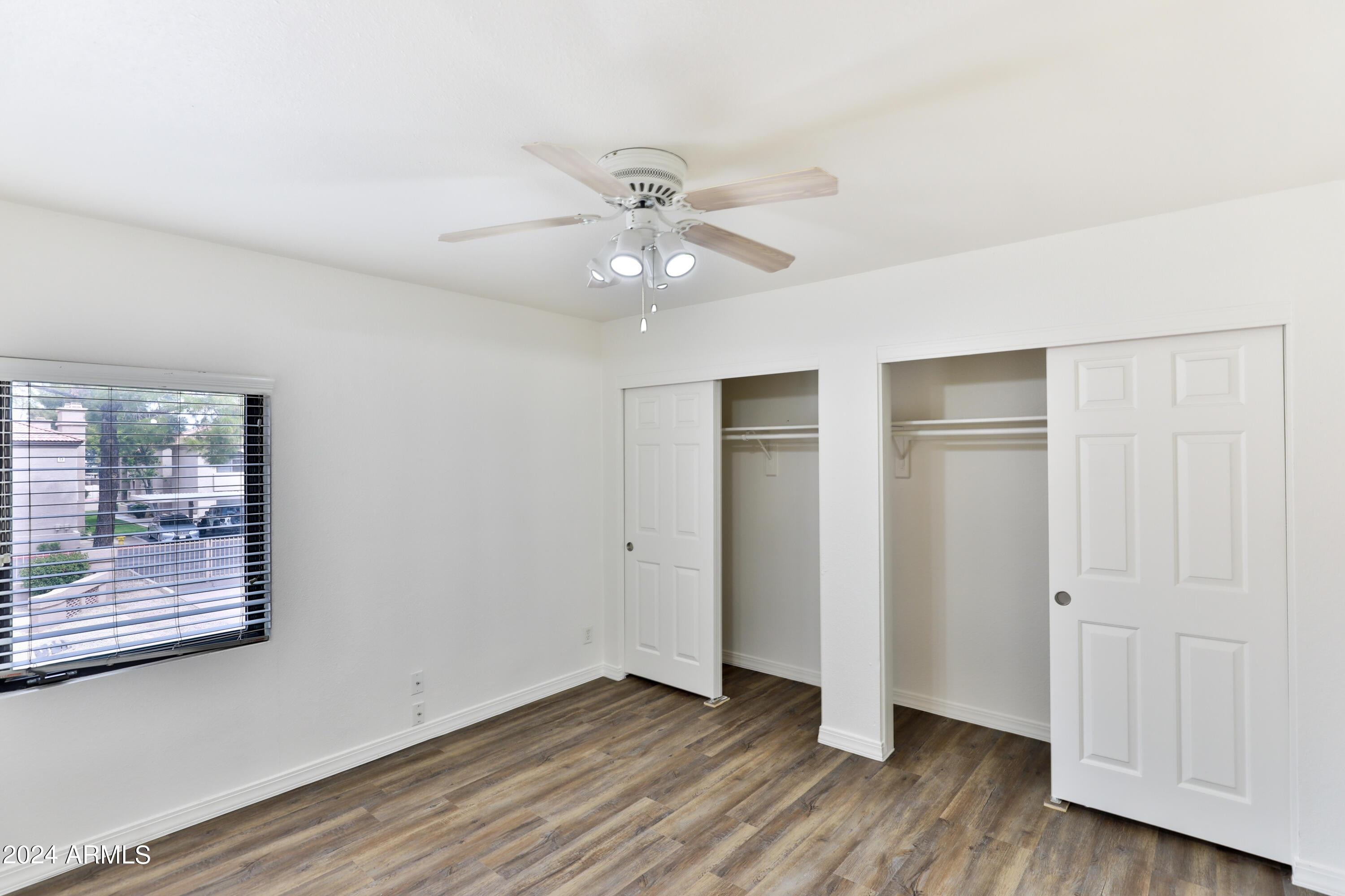 330 South Beck Avenue, Unit 201 Tempe, AZ 85281 - Photo 10 of 17 an empty room with wooden floor and a ceiling fan