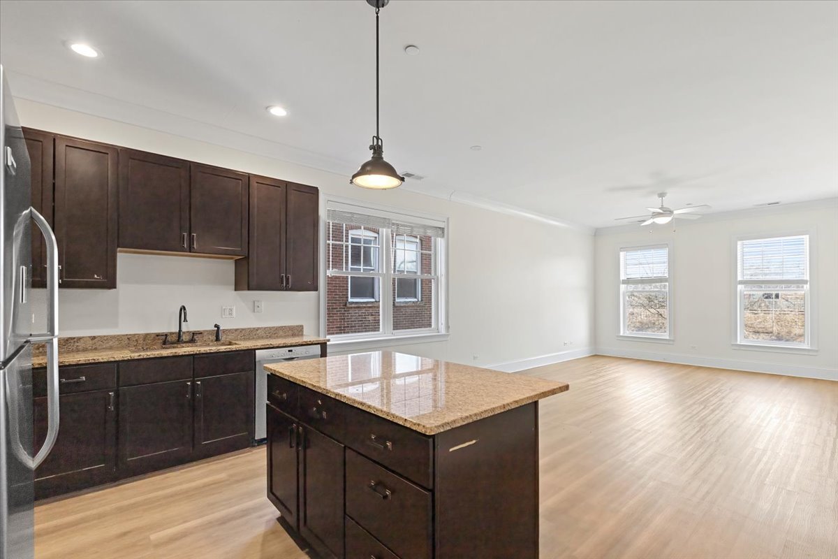 2500 Green Bay Road, Unit 201 Evanston, IL 60201 - Photo 2 of 9 a kitchen with a sink a center island cabinets and a window