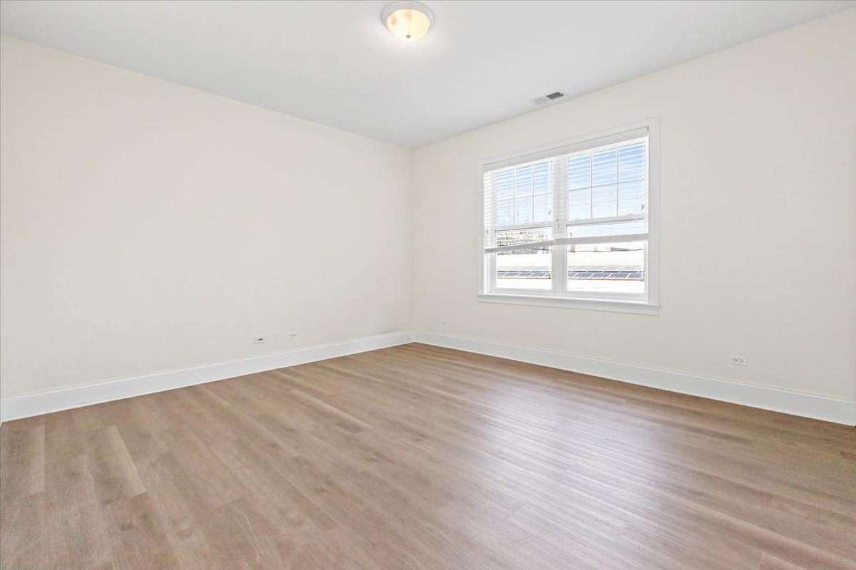 2500 Green Bay Road, Unit 201 Evanston, IL 60201 - Photo 6 of 9 an empty room with wooden floor and windows