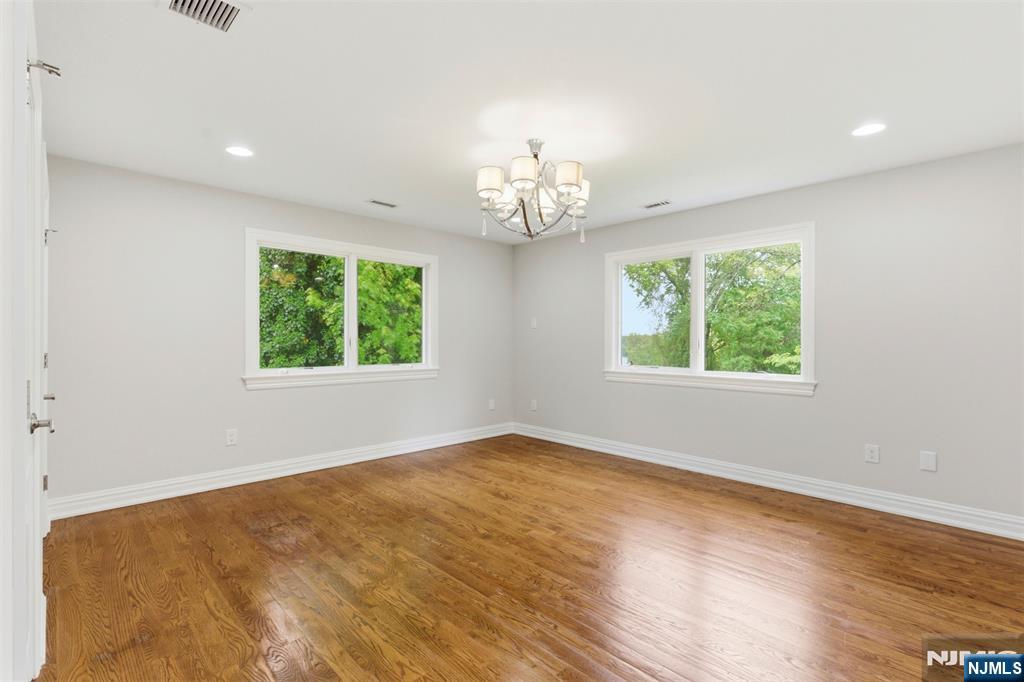 767 Orangeburgh Road River Vale, NJ 07675 - Photo 27 of 49 a view of an empty room with wooden floor and a window