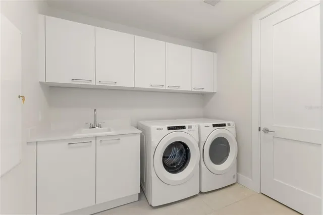 a dining room with wooden floor and large windows
