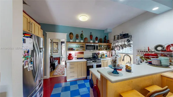 a kitchen with kitchen island a sink appliances and cabinets
