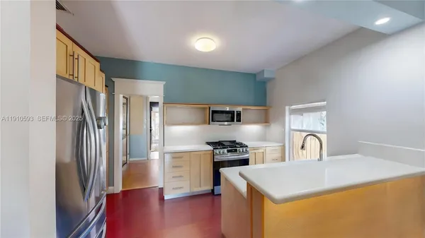 a kitchen with stainless steel appliances granite countertop a sink and a stove top oven