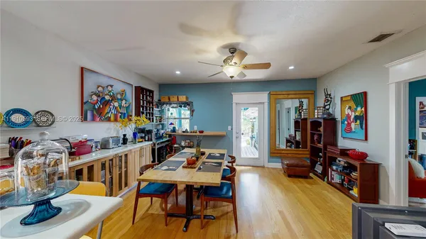 a view of a dining room with furniture and a kitchen