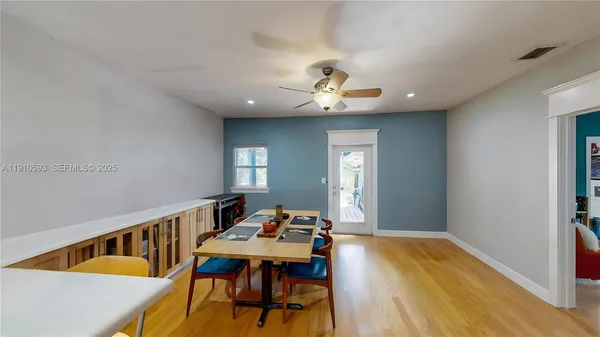 a view of a room with a ceiling fan and a bathroom