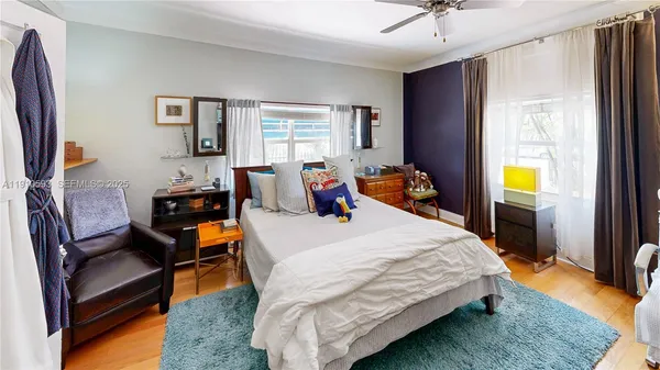 a living room with furniture and a book shelf