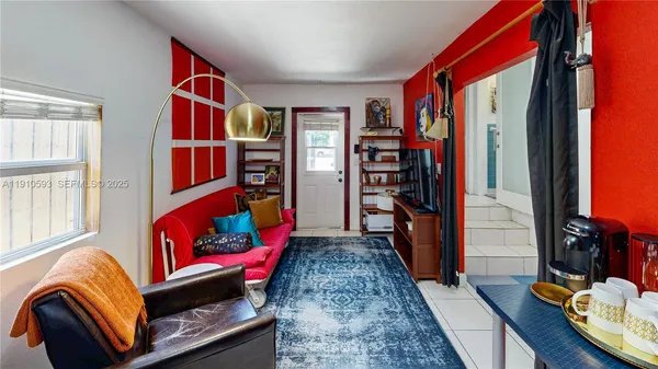 a backyard of a house with table and chairs potted plants