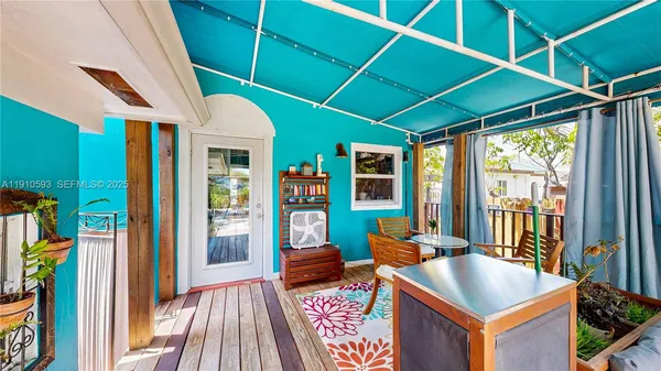 a wooden bench sitting in backside of a house with plants and trees