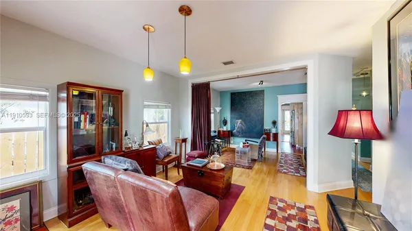 a view of a room with wooden floor and window
