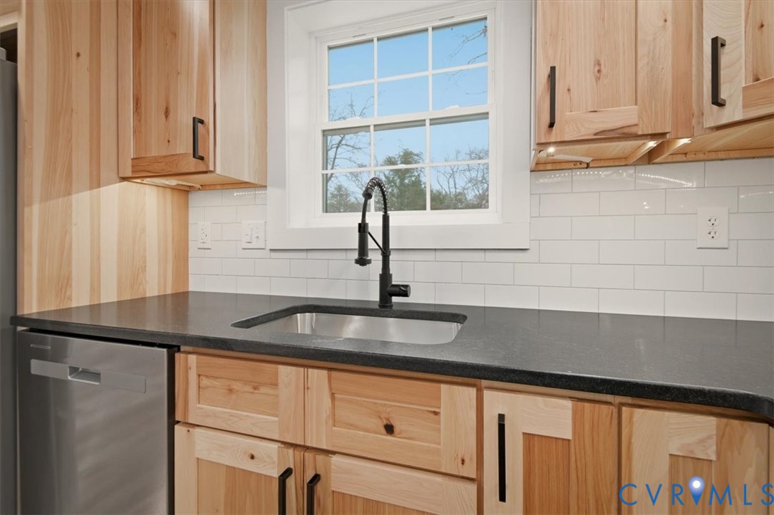 2495 Jackson Shop Road Goochland, VA 23063 - Photo 14 of 38 a kitchen with granite countertop a sink and a window